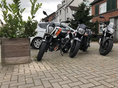 Ausbildungsmotorräder der Fahrschule vor der Filiale Köln Brück